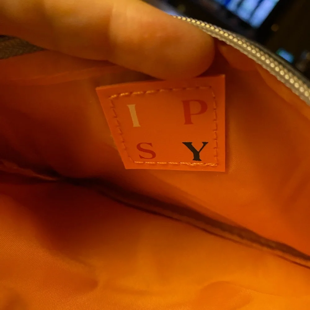 IPSY pouch with orange logo ribbon